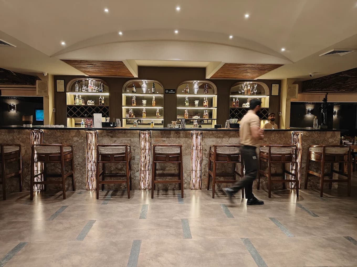 The marble bar counter and wooden stools inside Azure, Panchkula